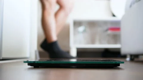 Cheerful happy dancing man gets on the floor scales. Body without fat. Stock Footage 218255982