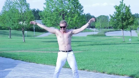 Cheerful happy guy dancing free style on the street Stock Footage 78938820