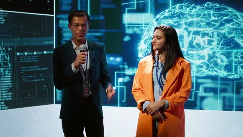 Cheerful host and expert guest talking at AI summit Video stock 278624966
