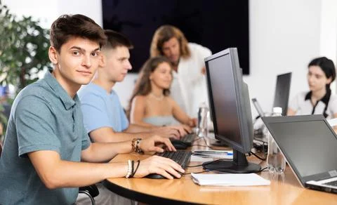 Cheerful interested guy using computer in student library Foto stock