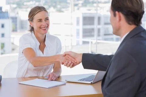Cheerful interviewer shaking hand of an interviewee Stock Photos