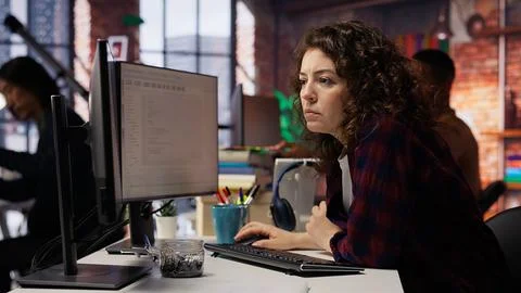 Cheerful IT expert using programming languages on PC in IT startup office Stock Photos
