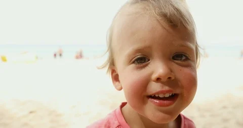 Cheerful kid standing on beach Stock Footage 100050953