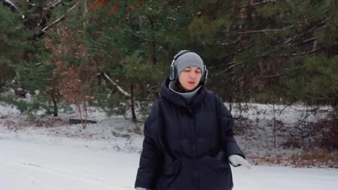 Cheerful lady exploring winter woods, Energetic woman demonstrating playful Stock Footage 324966124