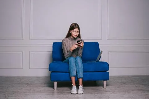 Cheerful lady using smartphone in light modern room Stock Photos