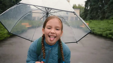Cheerful little girl looking at camera show tongue grimace face expression Stock Footage 273225053