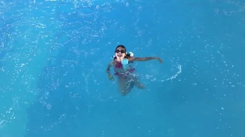 Cheerful little girl playing under water... | Stock Video | Pond5