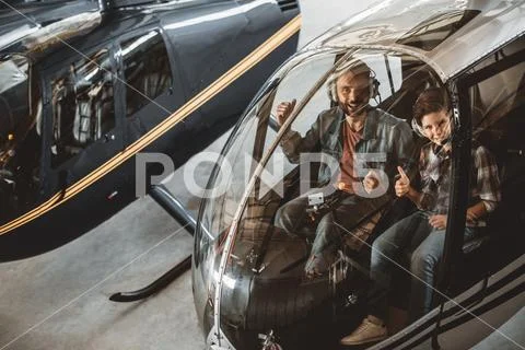 Cheerful male and boy in rotor plane Stock Photos