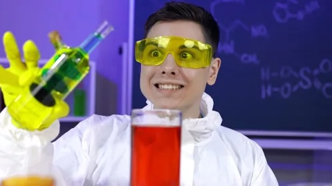 Cheerful male chemist is doing experiments in the laboratory. Stock Footage 166553295