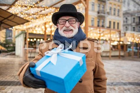 Cheerful male pensioner giving present Stock Photos