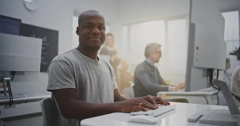 Cheerful Man Attends Programming Class, Smiling Brightly While Working on Stock Footage 321250216
