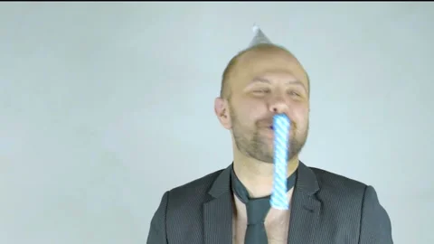 Cheerful man in a cap blows in a festive tune. Stock Footage 102965563