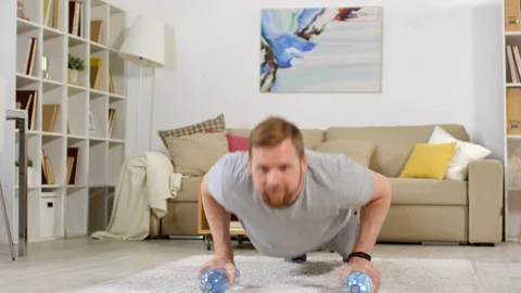 Cheerful Man Doing Push Ups during Home Workout Stock Footage 107177789