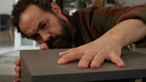 Cheerful Man Fitting on Top Panel while Assembling Flatpack Drawer Stock Footage 330508856