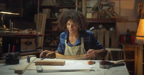 Cheerful man in good mood carpenter drawing furniture project sitting next to Stock Footage 140623909