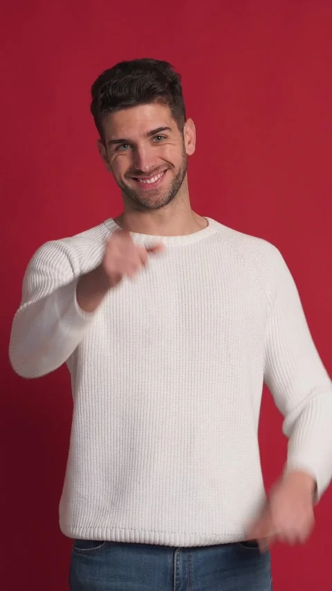 Cheerful man with hands on red background doing heart sign. Vertical video. Stock Footage 231249614