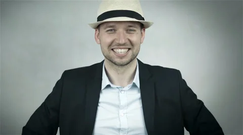 Cheerful man in hat and navy suit isolated on grey background 動画素材 39735312