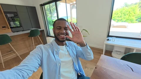 Cheerful man holding camera for a video call at Stock Footage 334636444
