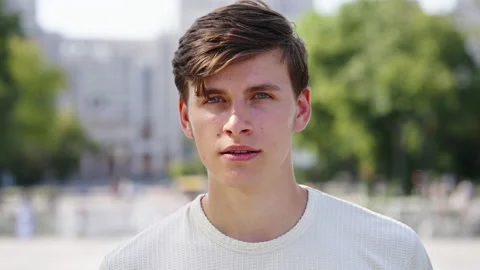 Cheerful man looking at camera in park Stock Footage 161428805