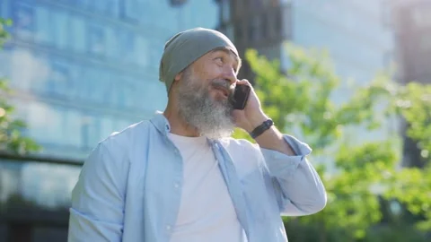 Cheerful man making call on cell phone outside Stock Footage 135465232