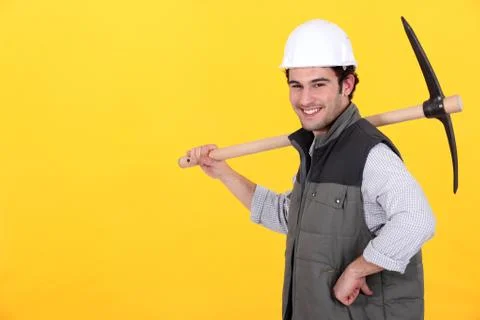 Cheerful man with a pickaxe Stock Photos