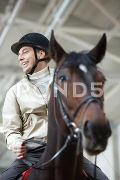 A cheerful man riding a horse Stock Photos