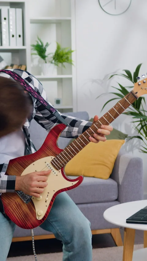 Cheerful man rocker playing electric guitar waving her hair. Bearded guy have fu Stock Footage 327615699