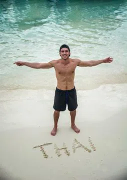 Cheerful man on sand beach Stock Photos