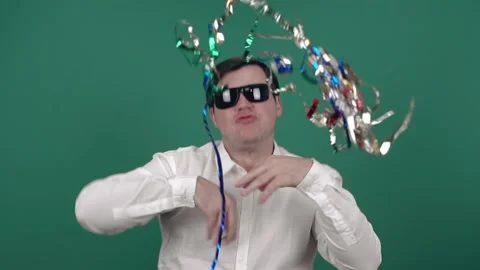 Cheerful man in sunglasses throws up colored confetti and dances. Stock Footage 150582443