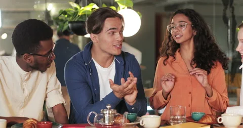 Cheerful man talking and gesturing while telling story to colleagues in modern Video stock 135797250