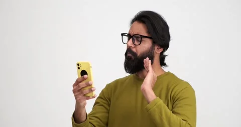 Cheerful man talking over video call on mobile phone Stock Footage 239454003