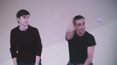 Cheerful man teaches juggling guy Stock Footage 169713101