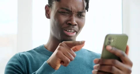 Cheerful man texting or reading funny message using mobile phone Видео 156756748