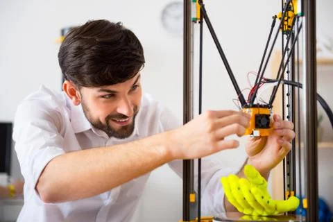 Cheerful man using 3d printer Stock Photos