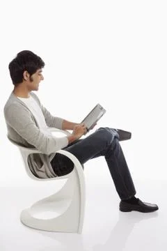 Cheerful man using a digital tablet Stock Photos