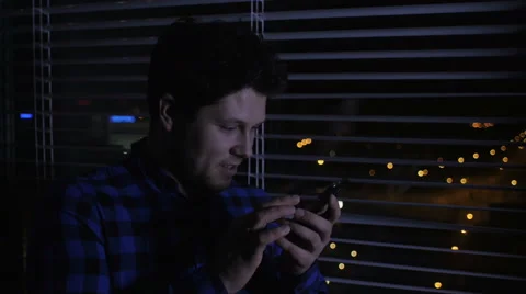 Cheerful man using smartphone at night. Stock Footage 57632211