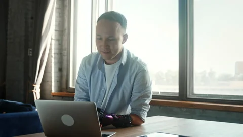 Cheerful manager guy with bio hand prothesis explains work Stock Footage 157349737