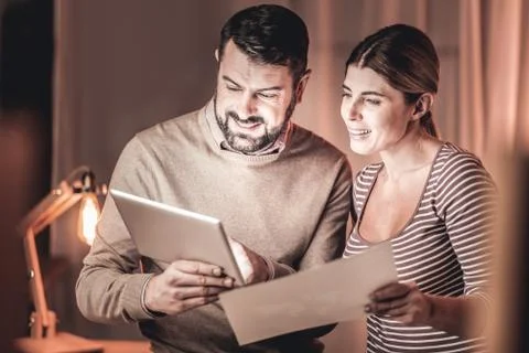 Cheerful managers comparing reports Stock Photos