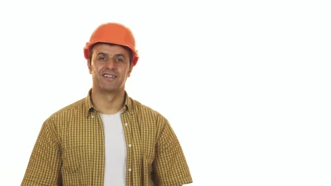 Cheerful mature builder in hardhat confidently posing with a drill machine Stock Footage 311939113