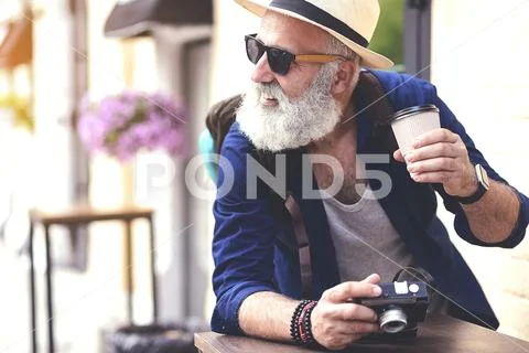 Cheerful mature tourist having break outside Stock Photos