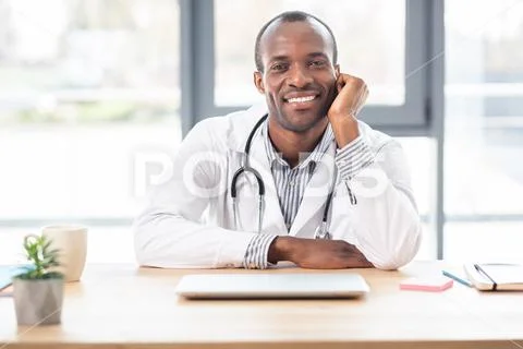 Cheerful medical worker posing on camera Stock Photos