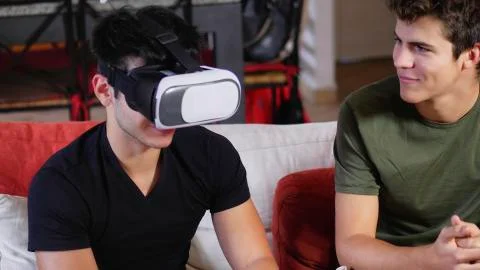 Cheerful men having fun with VR headset Stock Photos