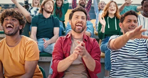 Cheerful mixed race people doing wave together at stadium during soccer match Stock Footage 260043751