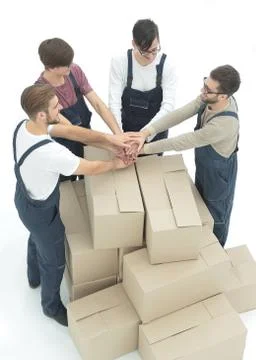Cheerful movers leaning on stack of boxes isolated on white back 写真素材