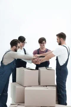 Cheerful movers leaning on stack of boxes isolated on white back 스톡 사진