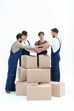 Cheerful movers leaning on stack of boxes isolated on white back Stockfoto's