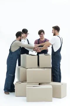 Cheerful movers leaning on stack of boxes isolated on white back Foto stock