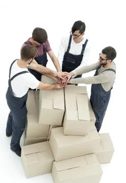 Cheerful movers leaning on stack of boxes isolated on white back Foto stock
