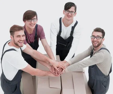 Cheerful movers leaning on stack of boxes isolated on white back Stock Photos