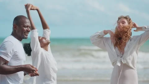 Cheerful Multicultural Friends Sharing Stories and Laughter on the Beach Stock Footage 314063549